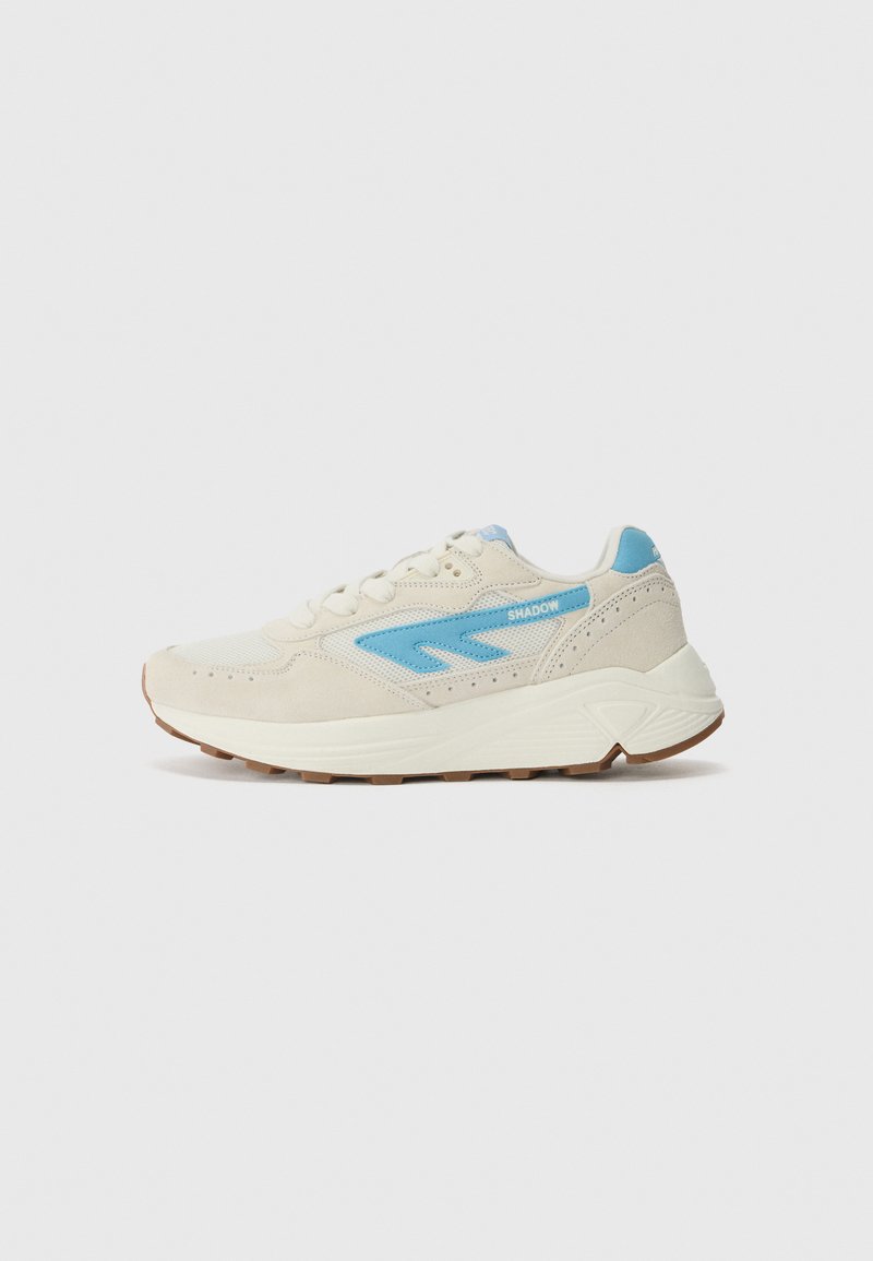 Beige sneakers with blue accents, featuring a mesh and suede upper, lace-up design, and a textured rubber sole for grip.