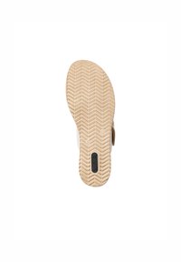 Semelle de chaussure avec une surface en caoutchouc beige texturé, présentant un motif en chevron et un détail de logo noir près du talon.