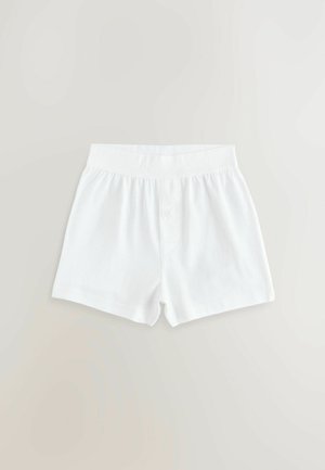 Bele bombažne kratke hlače z elastičnim pasom, z enim gumbom za zapiranje in preprosto, gladko teksturo. Brez vzorcev ali okraskov.