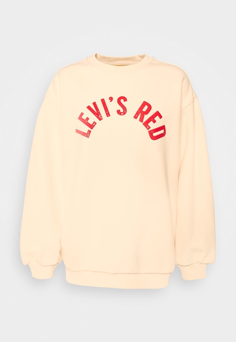 Sweatshirt de couleur crème avec col et poignets côtelés, arborant un texte en arc rouge imprimé « LEVI'S RED » sur le devant. Texture douce.