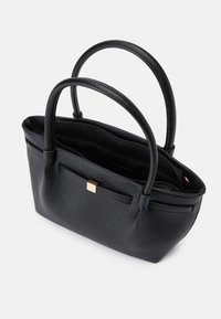 Black leather handbag with two round handles, zippered top closure, textured surface, front pocket, and gold-tone hardware accent.