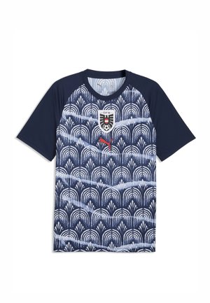 Marineblaues kurzärmeliges Sporttrikot mit weißem geometrischem Muster, rotem Puma-Logo und Wappen der österreichischen Fußballmannschaft auf der Brust.