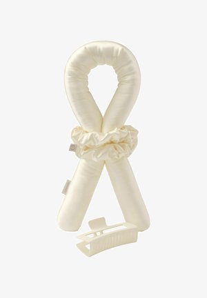 Soft cream-colored fabric hair curler with scrunchie and matching wide-tooth plastic hair clip on white background.