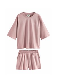 Set di abbigliamento da casa in cotone rosa composto da una maglietta a maniche corte dal taglio ampio e pantaloni corti con vita elasticizzata, entrambi con un discreto dettaglio del logo.