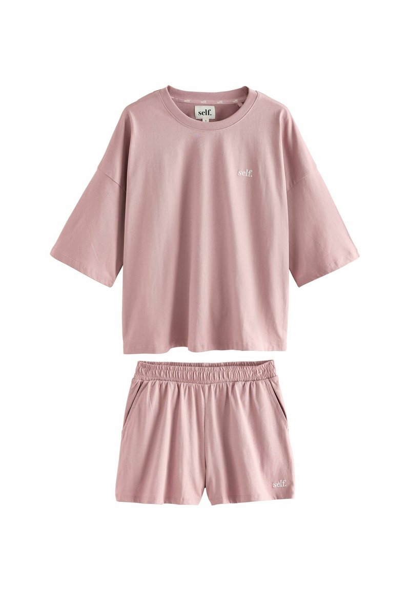 Set di abbigliamento da casa in cotone rosa composto da una maglietta a maniche corte dal taglio ampio e pantaloni corti con vita elasticizzata, entrambi con un discreto dettaglio del logo.