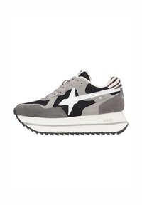 Gray and black sneaker with white star logo, thick white sole, and zebra-striped heel detail, side view on white background.
