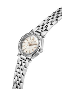 Nerūsējošā tērauda pulkstenis ar astoņstūru korpusu, pērļu krelles ciparnīcu, rozā zelta akcenteiem un kristāla apmali. Iekļauts saistīts rokassprādze.