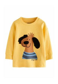 Camicia a maniche lunghe in cotone gialla con una grafica di un cane con faccia marrone, orecchie nere e una maglietta a righe blu. Testo "Rimani fresco" incluso.