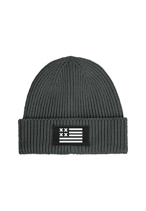 Knitted gray beanie with ribbed texture, featuring a black patch displaying a white flag design. Accented with horizontal and vertical stripes.