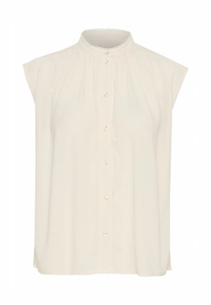 Krém színű, ujjatlan blúz, gombos elejével, fodros gallérral és finom redőzéssel az egész mellen.