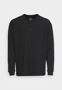 Black long-sleeve Nike T-shirt with small black embroidered logo on chest, crew neckline, and ribbed cuffs.