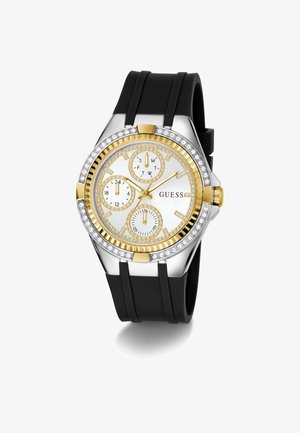 Montre analogique en or et argent avec un cadran blanc, trois sous-cadrans, accents en cristal et un bracelet en caoutchouc noir. Présente des index horaires audacieux.