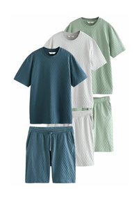 Four sets of textured knit apparel: two short-sleeve shirts and shorts in teal, gray, white, and light green. Features elastic waistbands.