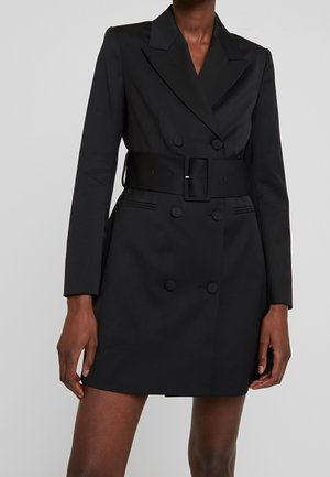 Black double-breasted blazer dress with a belt, featuring a tailored fit, sharp lapels, and large buttons on the front and cuffs.