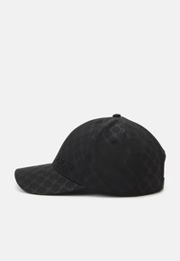 Black cap featuring a textured geometric pattern, embroidered logo, and a curved brim. Made from lightweight fabric with eyelets.