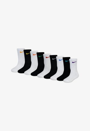 Nike socks in black and white, featuring ribbed texture and colored swoosh logos in orange, green, red, blue, and purple.