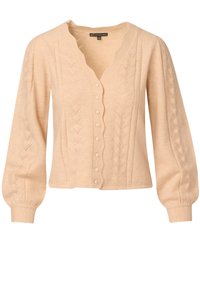Beżowy kardigan z dekoltem w serek, falbaniastymi krawędziami oraz dekoracyjnymi wzorami liści. Posiada długie, bufiaste rękawy i rząd guzików z przodu.