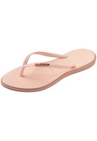 Pink rubber flip-flop featuring a textured footbed, thin straps, and a decorative logo detail near the thong, all in matching pastel tones.