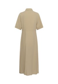Beige jurkje met korte mouwen, een polokraag en een uitlopende rok. Gemaakt van een textuurstof, met een nauwsluitende taille en een zoom tot op de knie.