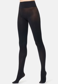 Collant neri opachi con vita alta. Texture liscia e setosa; lunghi fino alla caviglia senza motivi o dettagli. Adatti a vari outfit.