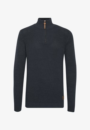 Pullover lavorato a maglia di un blu navy scuro con mezza cerniera. Presenta un motivo testurizzato sul corpo e polsini e orlo a coste. Etichetta in pelle sul lato.