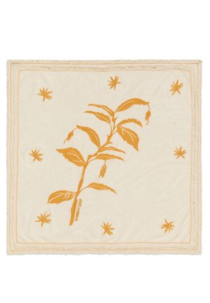 Plaid en coton avec un fond crème, ornée d'un motif de plante orange brodé et de petites étoiles, bordée d'une frange discrète.