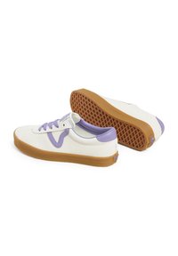 White canvas sneakers with purple accents, featuring a textured rubber sole and lace-up design. Notable gum sole with a patterned grip.