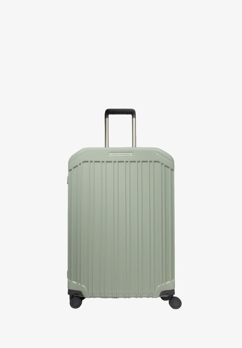 Maleta rígida en verde claro, con ranuras verticales, asa negra retráctil, cuatro ruedas y un acabado elegante y suave.