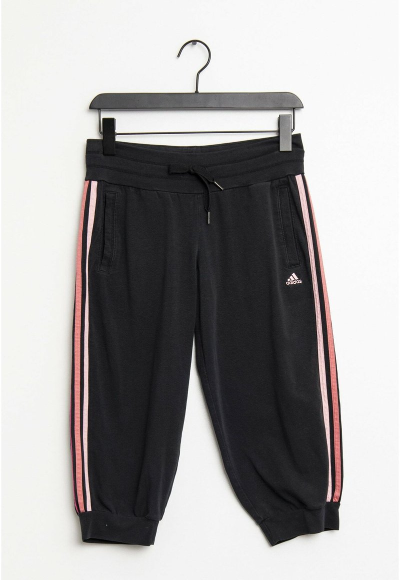 Schwarze Sportpants aus weichem Material, mit pinken Seitestreifen, elastischem Bund, Kordelzug und gerippten Säumen. Mit Fronttaschen.