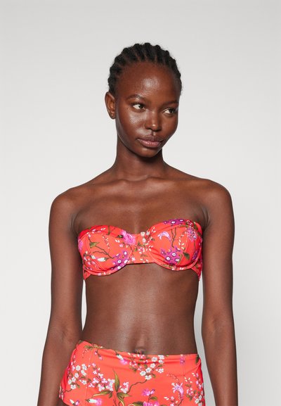 Red floral bikini top with a structured design, featuring a sweetheart neckline, floral patterns, and a smooth, shiny texture.