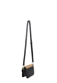 Black leather crossbody bag with a textured beige accent on top, gold hardware, and an adjustable shoulder strap. Compact rectangular shape.