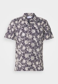 Chemise à manches courtes boutonnée avec grand imprimé floral marguerite noir et blanc et col pointu.