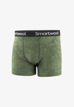 Oliwkowo-zielone bokserki z kwiatowym wzorem, czarny pas z białym logo „Smartwool” oraz mała wielokolorowa metka przy krawędzi.