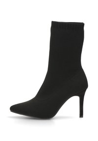 Botas de tobillo estilo calcetín negras con punta afilada, tacón stiletto alto y material de punto suave y elástico. Sin adornos adicionales.