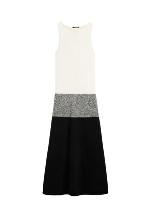 Mouwloze midi-jurk met een aansluitende witte top, een grijze middenpartij met vlekjes en een uitlopende zwarte rok aan de onderkant.