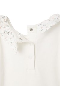 White cotton garment with a floral-patterned collar, featuring snap buttons at the neckline and a smooth texture.