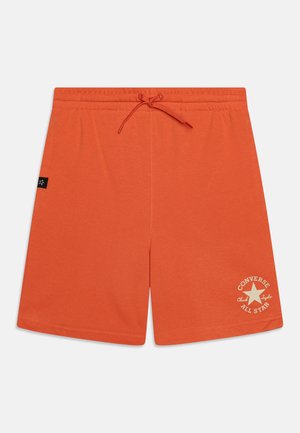 Shorts en coton orange avec une taille élastique et un cordon de serrage. Présente un logo étoile Converse imprimé en crème sur le bas à gauche.