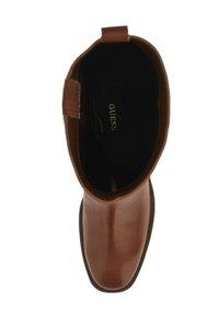 Stivale alla caviglia in pelle marrone con punta rotonda, texture liscia e interno nero. Presenta un logo all'interno e un tacco leggero.