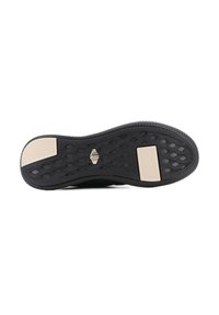 Semelle de chaussure en caoutchouc noir avec une surface texturée, comportant deux sections beige accentuées et un motif hexagonal pour une meilleure adhérence.
