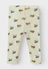 Ljuskrämfärgade leggings med ett upprepat mönster av vintageflygplan i nyanser av brunt, blått och grått. Mjuk, stretchig tyg.