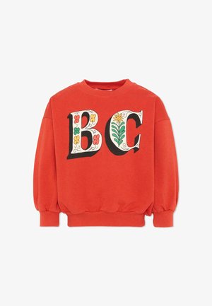 Sweat-shirt rouge avec de grandes lettres décoratives "B" et "C" ornées de motifs floraux colorés sur le devant, poignets et ourlet côtelés.