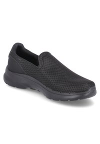 Schwarze Slipschuhe mit einem strukturierten Mesh-Obermaterial, gepolsteter Sohle und abgerundeter Zehenpartie, die für Komfort und einfaches Anziehen entworfen sind.