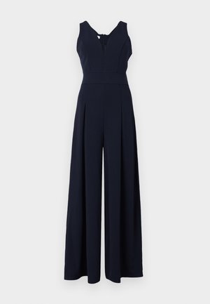 Navy jumpsuit with a deep V-neck, sleeveless design, and wide pleated legs. Crafted from smooth, lightweight fabric with a back zipper.