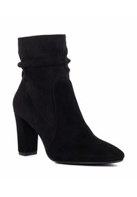 Black suede ankle boot with a slouchy design, pointed toe, and a high block heel. Features subtle stitching and a smooth texture.