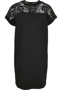 Robe noire longueur genou avec manches courtes et détail en dentelle florale sur le haut de la poitrine, les épaules et les manches.