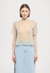Průhledný top s krátkým rukávem v béžové barvě s světle modrými detaily. Jemný, lehký materiál s volným střihem, doplněný o světlou džínsovou sukni.