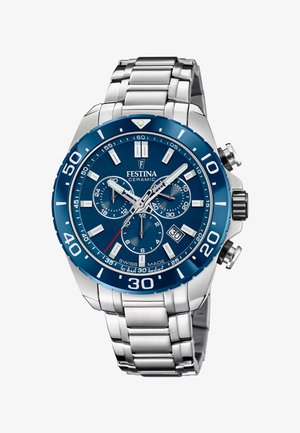 Zegarek ceramiczny Festina z niebieską tarczą i bezelą, srebrna bransoleta ze stali nierdzewnej. Posiada trzy subtarczki, luminescencyjne wskazówki oraz wyświetlacz daty.