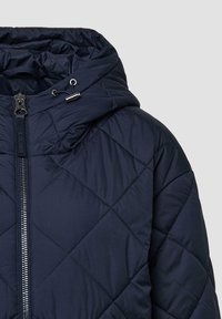 Marineblauwe gewatteerde jas met capuchon, voorzien van een voorrits, trekkoordaccenten en een gladde textuur. Diagonaal stikpatroon overal.