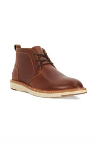 Brown leather ankle boot with rounded toe, contrasting stitching, and a light-colored sole. Features a lace-up design and pull tab.