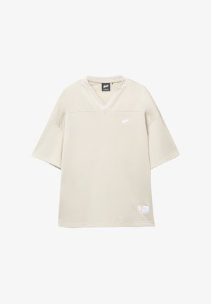 Vaalea beige verkkomateriaali lyhythihainen paita V-pääntiellä, jossa on brändilogo rinnassa ja etiketti helman kohdalla. Tuntuva, hengittävä materiaali.